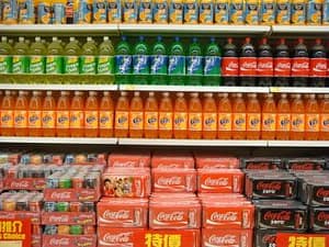 Sugar-sweetened beverages A picture of rows of sugar-sweetened beverages on the shelves of a grocery store