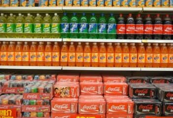 Sugary beverages arranged on the shelves of a grocery store