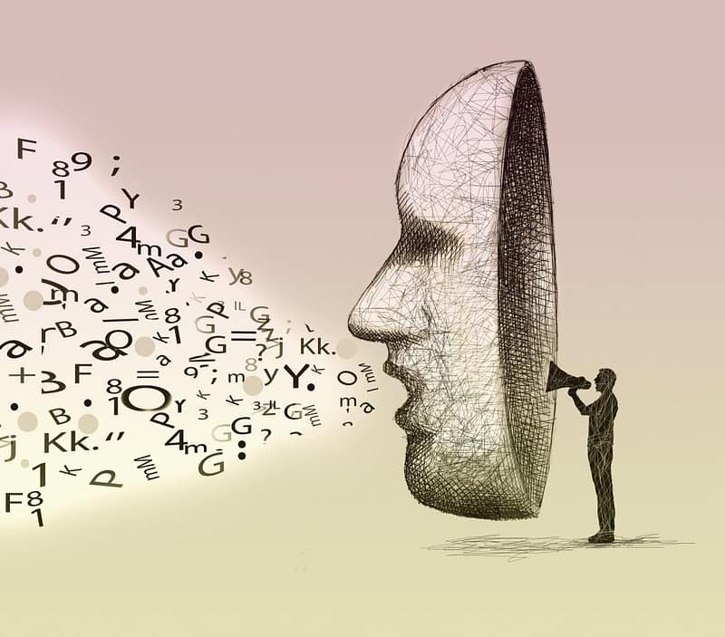 A silhouette figure speaking into a mask signifying how social media can amplify anything, good or bad.